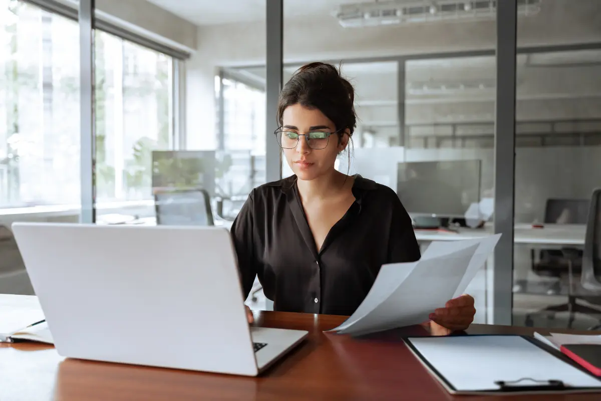 Business professional reviewing annual reports and operating agreements documents for LLC compliance and state filing requirements