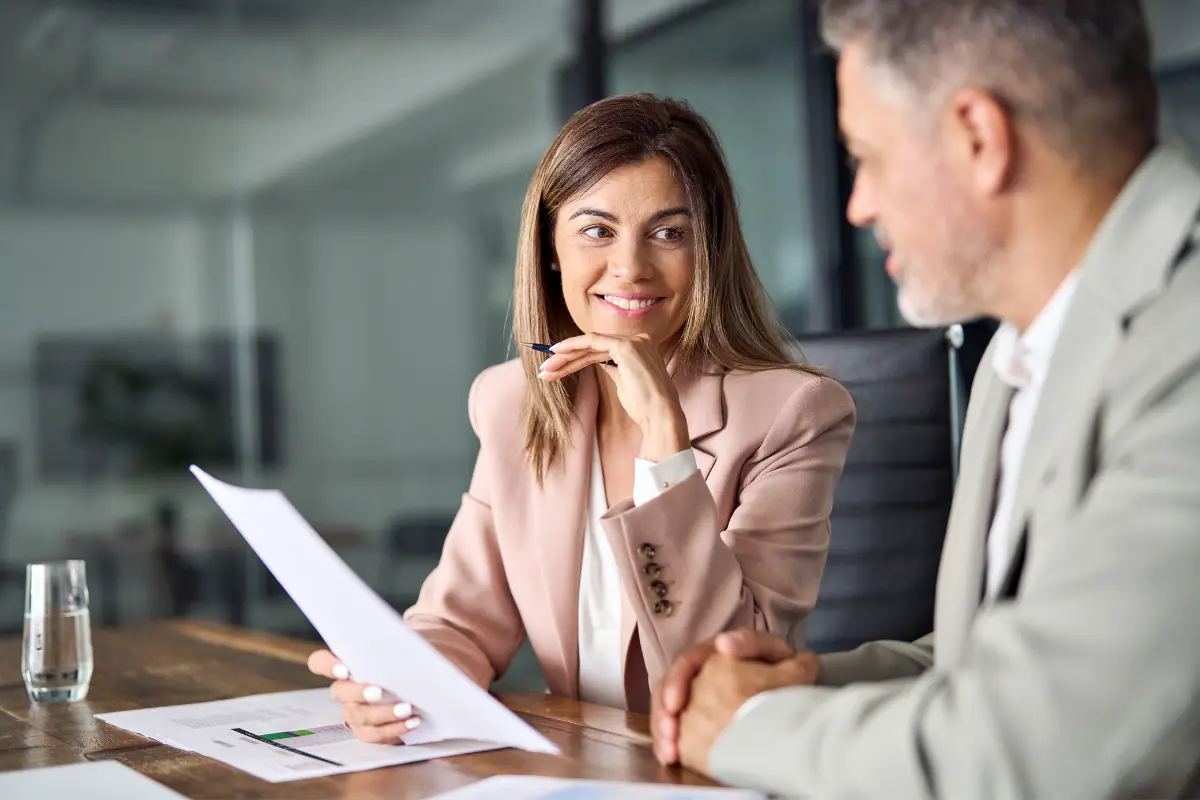 Business professionals discussing benefits of forming an LLC and why small businesses should form an LLC for personal asset protection and tax advantages.