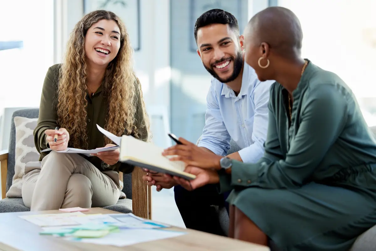 Diverse business partners reviewing succession planning documents for small business continuity.