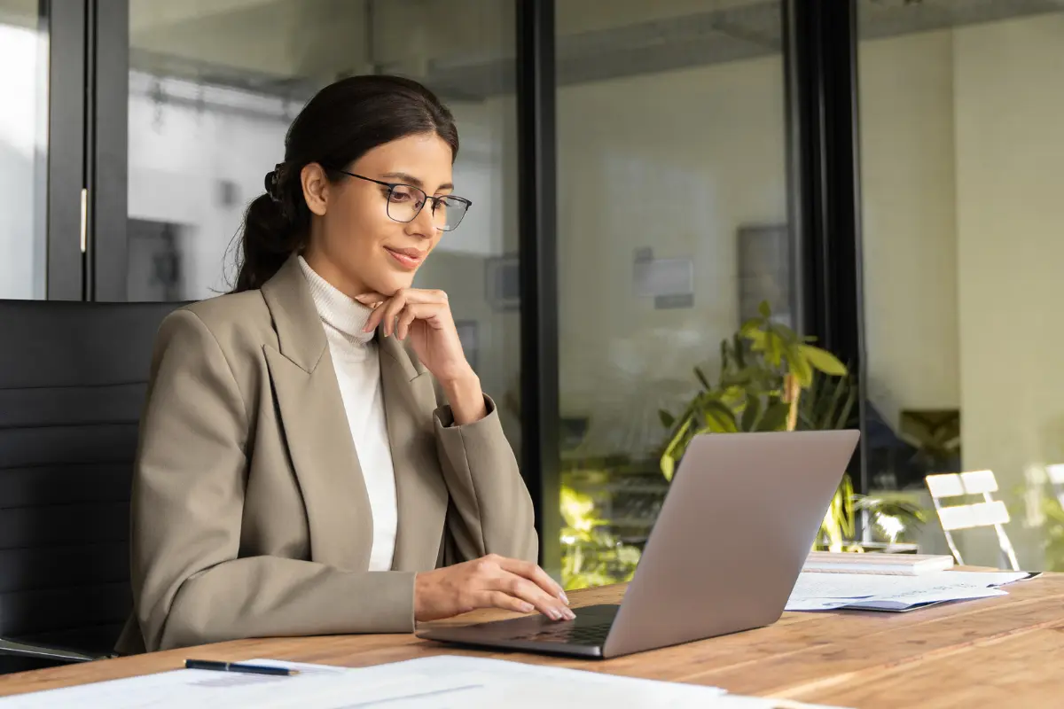 Entrepreneur researching business scaling versus growth strategies and how to scale a small business sustainably on laptop