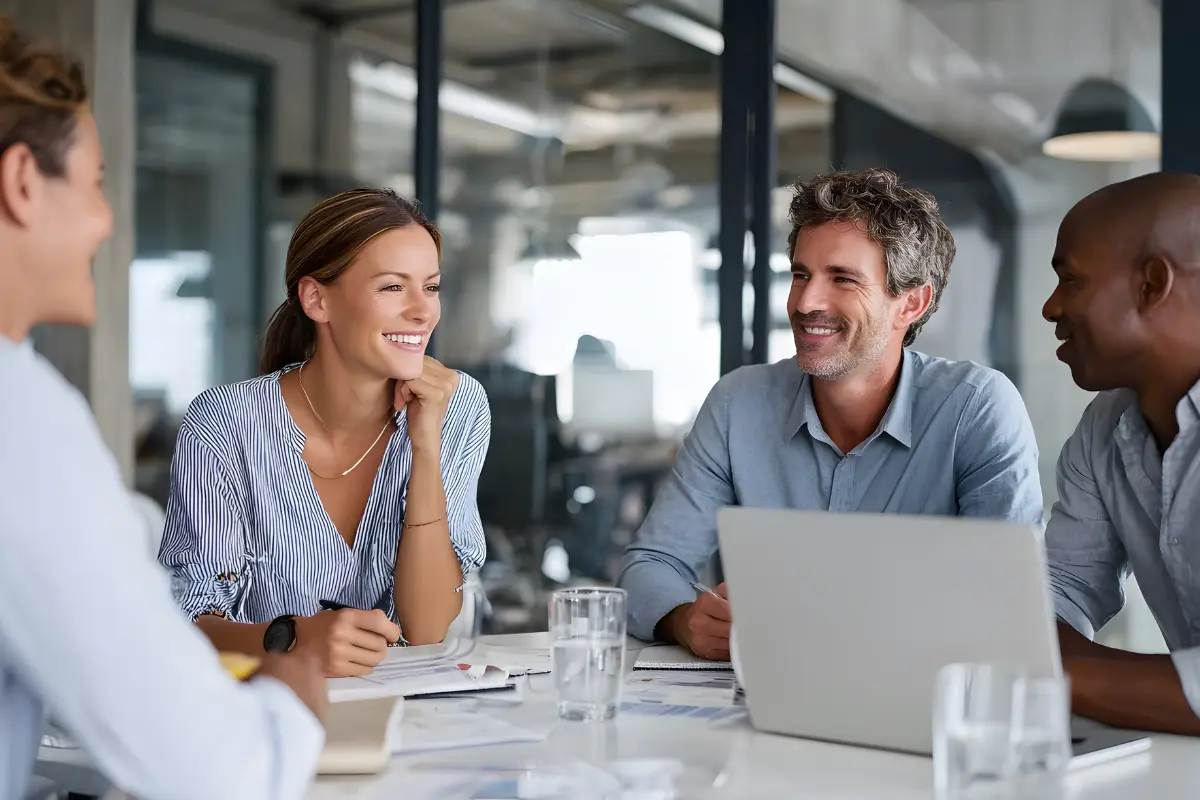 Small business team meeting discussing compliance officer responsibilities and regulatory requirements for ethical operations