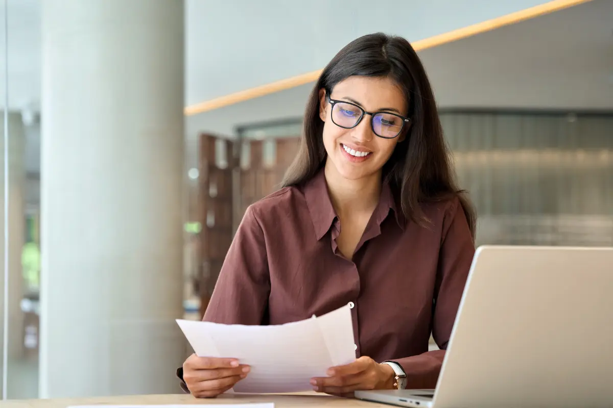 Female business professional reviewing an automated entity management dashboard with compliance alerts and deadlines.