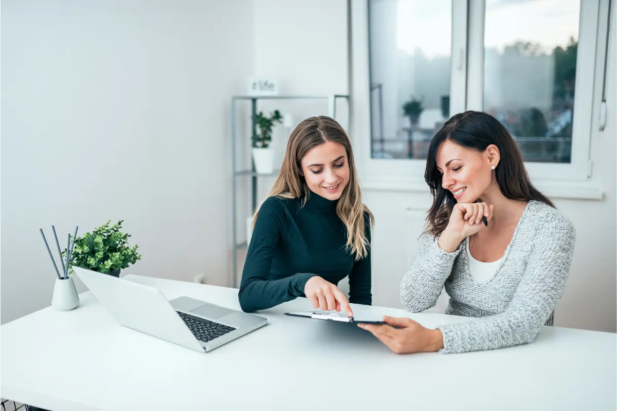 Business owners consulting about registered agent costs and hiring professional registered agent services for business compliance and legal document handling.