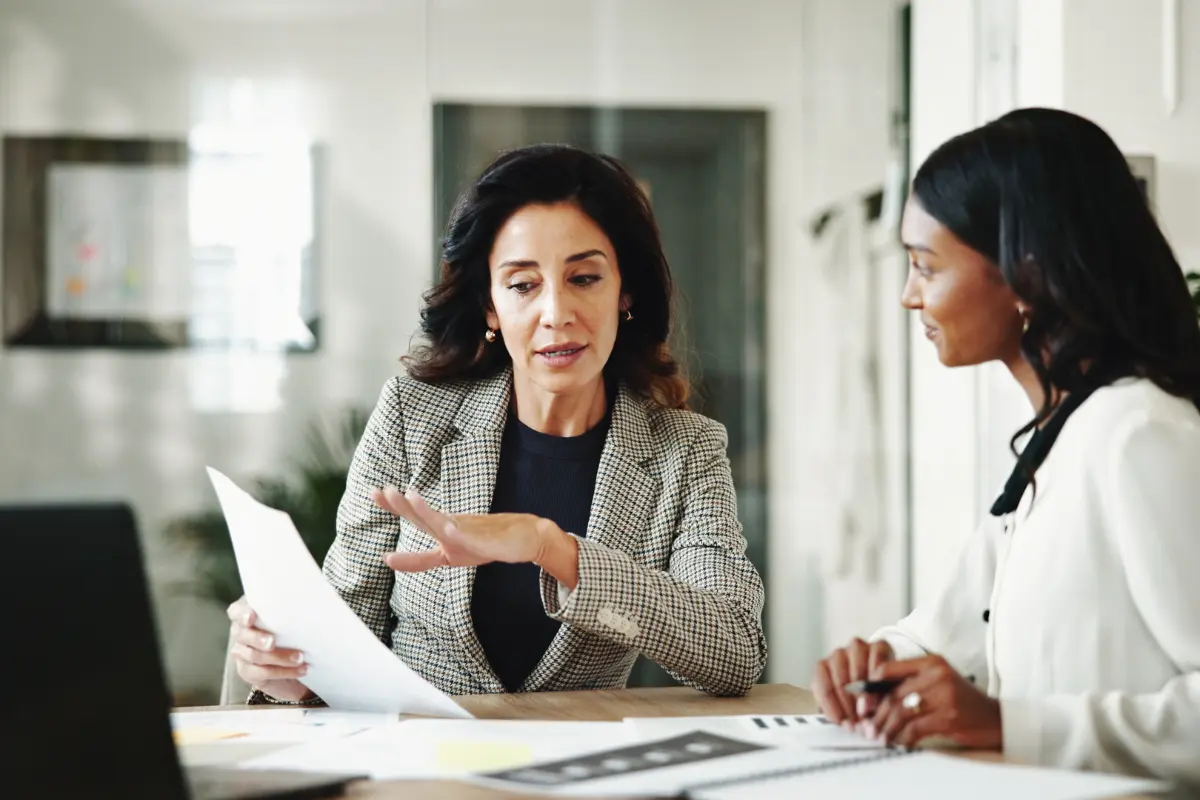 Business professionals reviewing LLC winding up procedures and discussing steps to dissolve an LLC and filing articles of dissolution requirements.