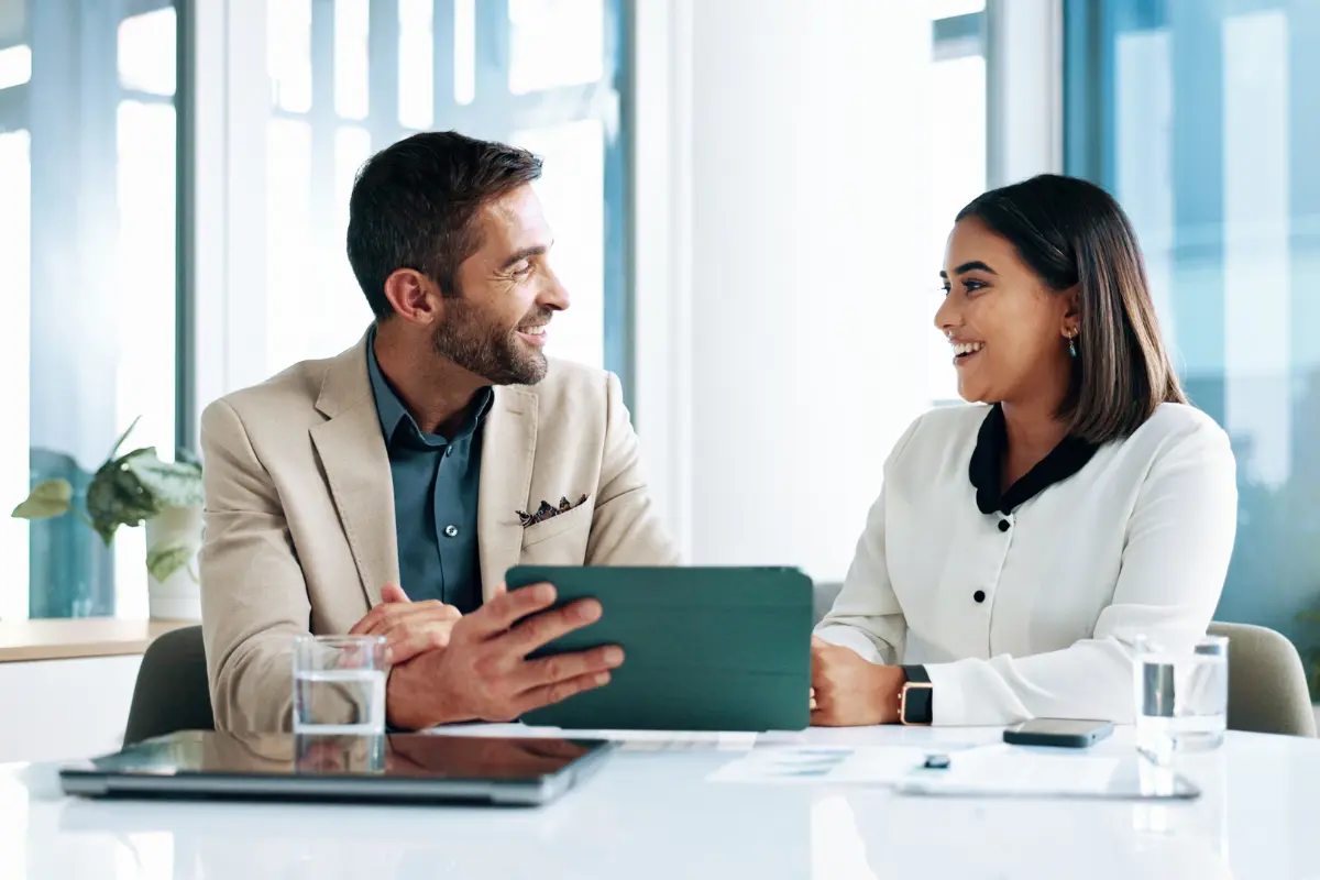 Business professionals discussing how to file for foreign qualification online and certificate of authority requirements for expansion