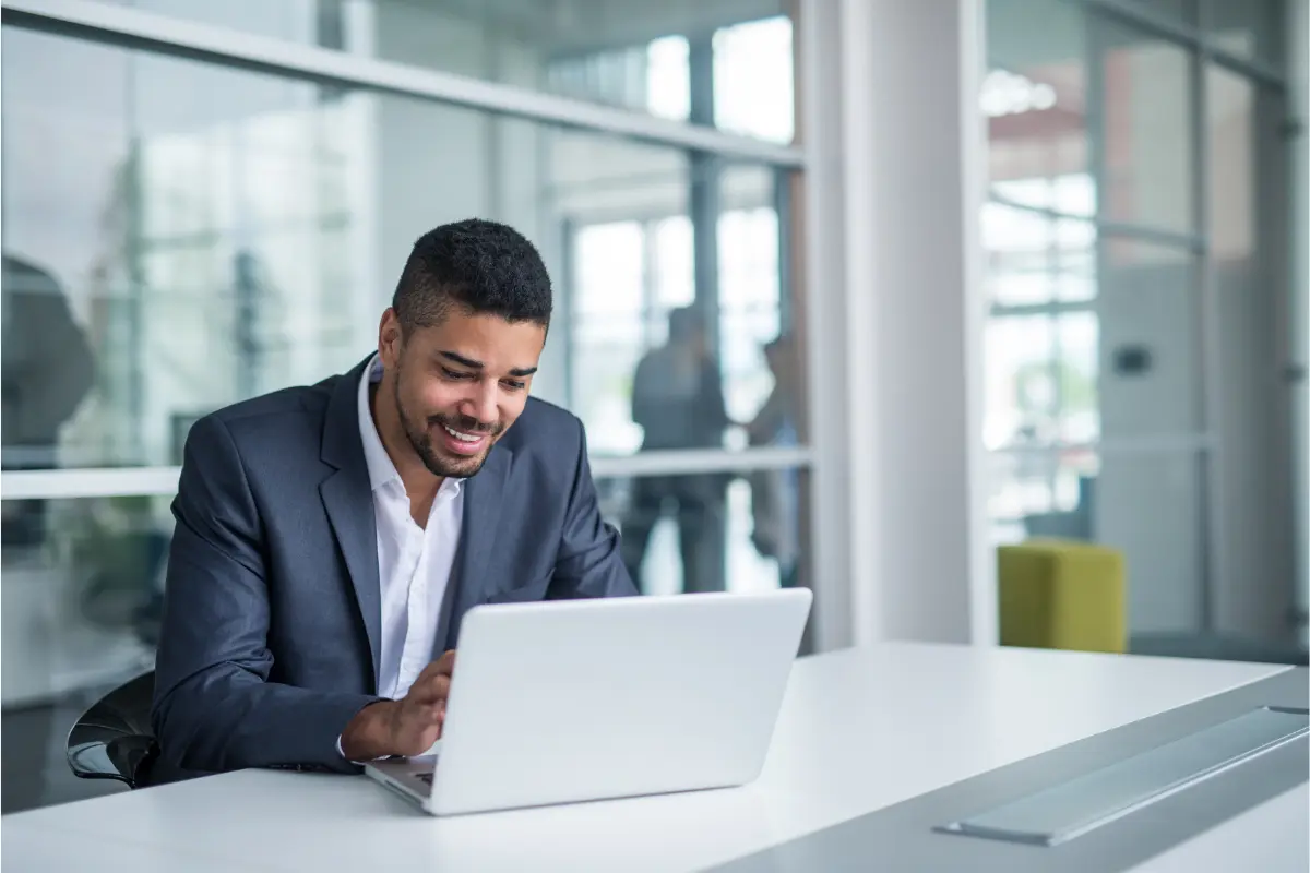 Professional entrepreneur working on laptop choosing business name and researching naming ideas for new company startup.