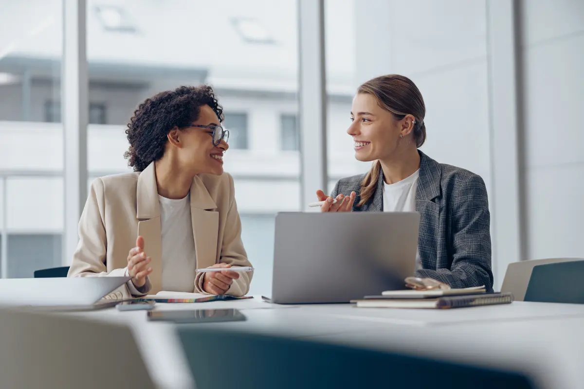 Two business owners discussing how to convert an LLC to a corporation and the steps required for LLC to Inc conversion