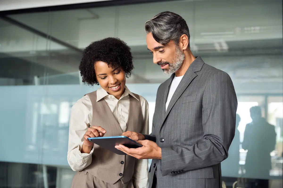 Business professionals comparing LLC vs nonprofit organization legal and financial structure differences on tablet