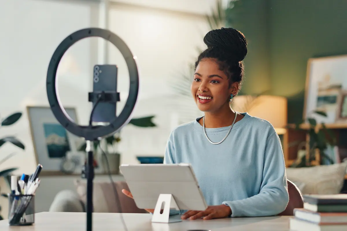 Content creator running a side hustle from home using professional recording and business tools.