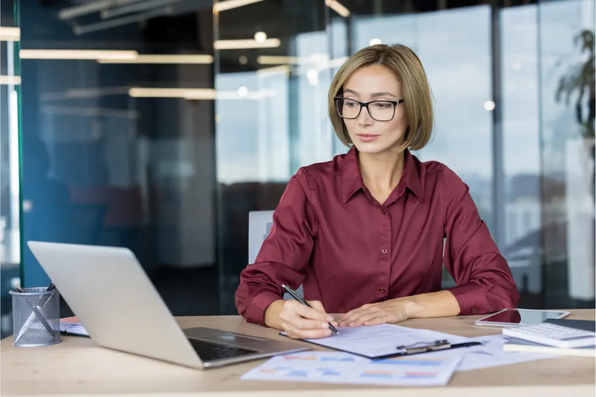 Corporate officer drafting an LLC resolution and corporate approval document at desk using a corporate resolution template for business decision documentation